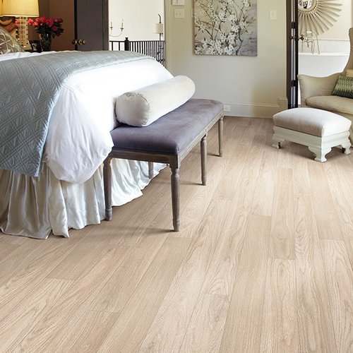 Bed on laminate floor from Prestige Flooring Center in Cathedral City, CA
